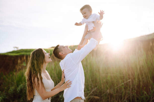istock Father, mother and child resting on the beach. 1396885307