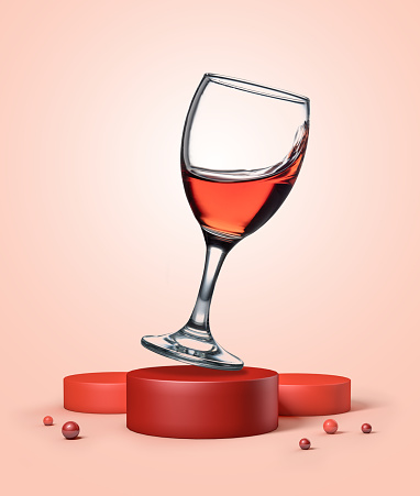 Red wine glass on geometric podium platform