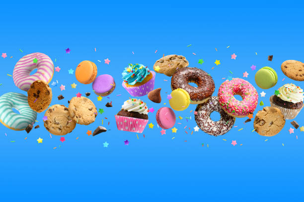 istock Donuts, cupcakes, cookies, macarons flying on blue background. 1396887262
