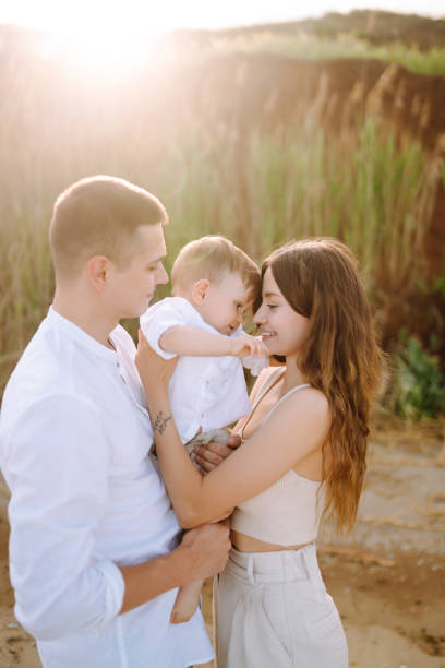istock Father, mother and child resting on the beach. 1396887269