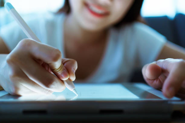istock Woman drawing an illustration on tablet. 1396887358