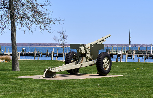 Bellport, NY USA - May 1, 2022: An artillery gun in Osborn Park near Bellport marina on an early spring day