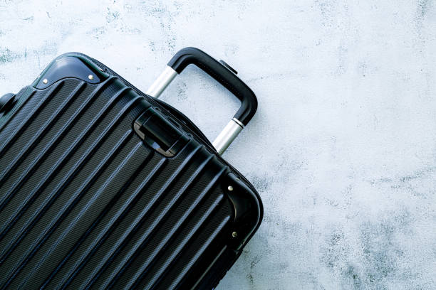istock Black travel bag,Black luggage set on dark background, top view image, flat lay composition. Travel minimalist concept, black and dark classic baggage mockup, small and big. Suitcase accessory set, journey concept. 1396888551