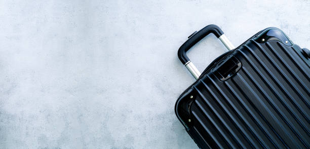 istock Black travel bag,Black luggage set on dark background, top view image, flat lay composition. Travel minimalist concept, black and dark classic baggage mockup, small and big. Suitcase accessory set, journey concept. 1396888555