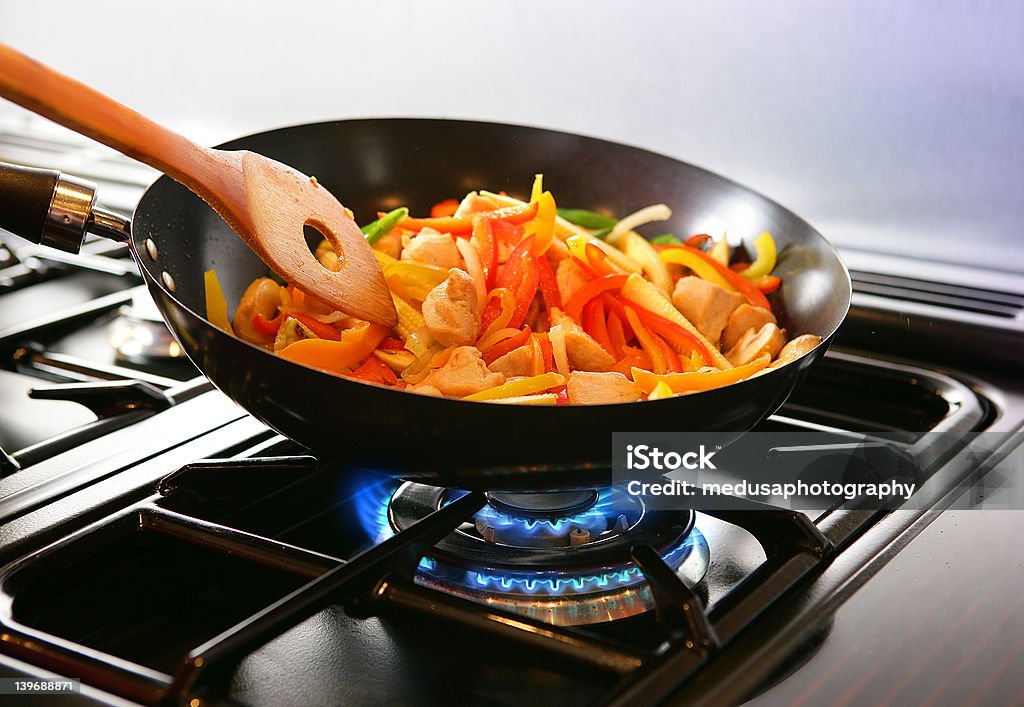 Wok cooking Stirfry Wok cooking Stirfry vegetables and chicken on Gas flame. Cooking Stock Photo