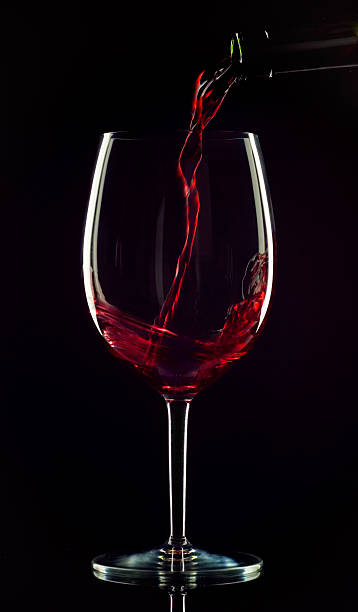 ワイングラスに注がれる - wine pouring wineglass red ストックフォトと画像