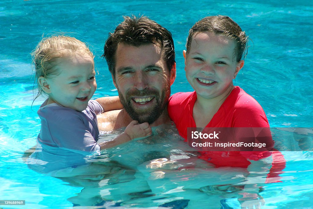 Summer Family Fun Photo of two children with their dad. Adult Stock Photo