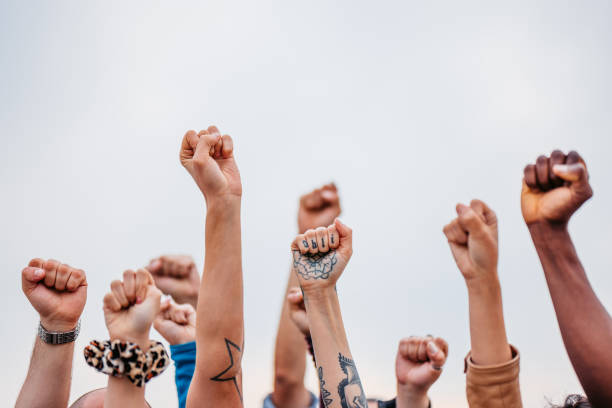 istock Protestors Raising Fists 1396890165
