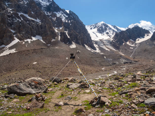 automatic weather station in the mountains. distant mountain range, obtaining seismic and meteorological data. - anemometer meteorology measuring wind imagens e fotografias de stock