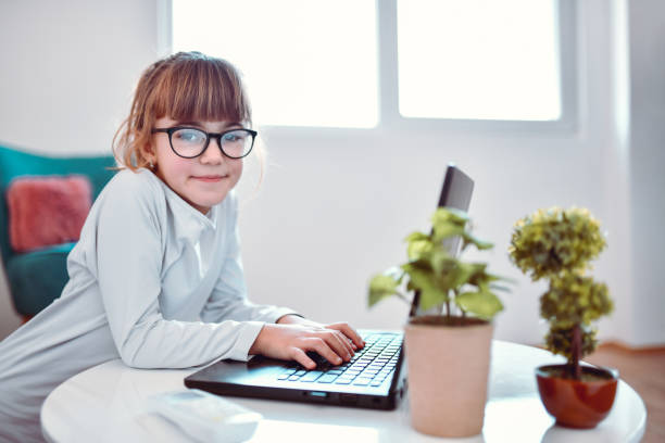 istock Female Child Using Laptop At Home 1396892975