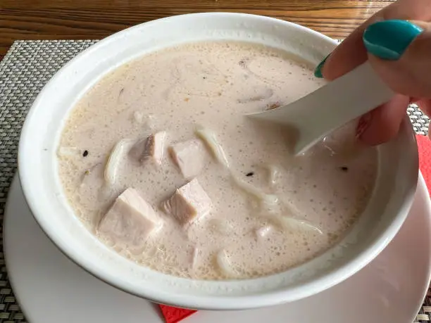 Photo of Creamy soup with chicken and noodles.