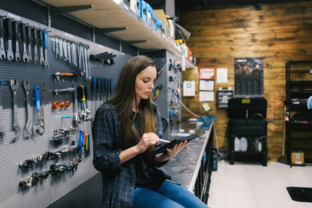 istock young woman typing with digital pen on tablet in workshop 1396893763
