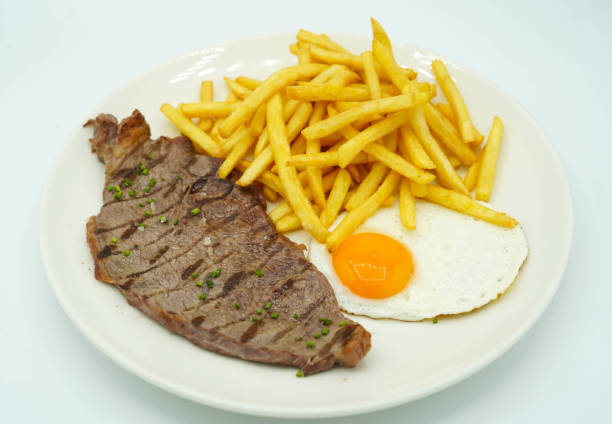 istock Combination plate of beef steak with potatoes and fried egg 1396893772