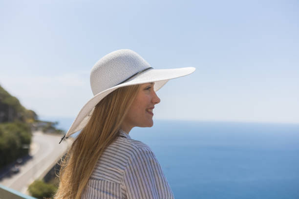 She smiles and looks off towards Mediterranean Sea in the distance