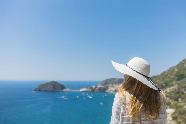 Young woman relaxes at coastal viewpoint