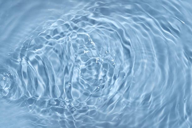 istock Circles on water. Blue round shadows. Blurred background made with water and light in monochrome. 1396895242