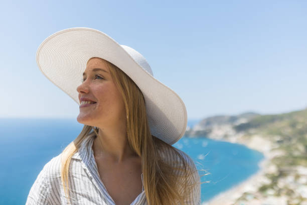 istock Young woman relaxes at coastal viewpoint 1396895276