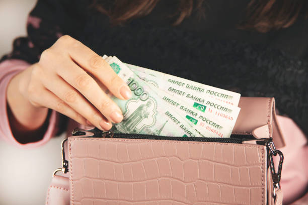 istock woman hand money with bag 1396895300