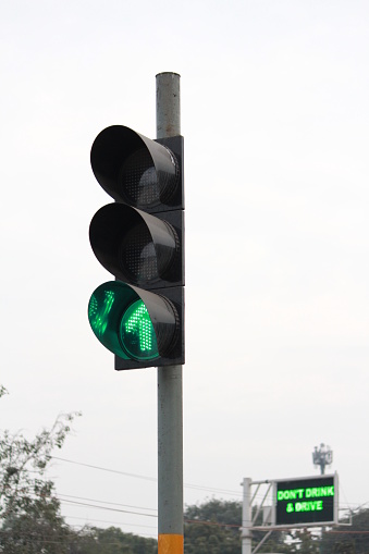 Green traffic signal on the right indicates to go