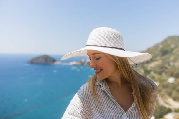 istock Young woman relaxes at coastal viewpoint 1396895484