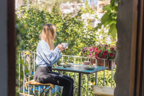istock Young woman enjoys a healthy breakfast outside 1396895528