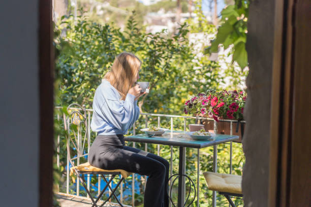 istock Young woman enjoys a healthy breakfast outside 1396895581