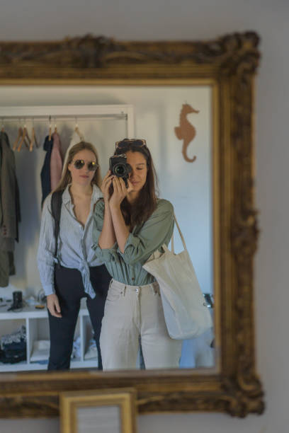 istock Friends take selfies in gold mirror, with DSLR camera 1396895643