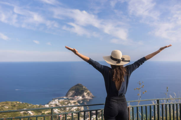 Young woman relaxes at coastal viewpoint