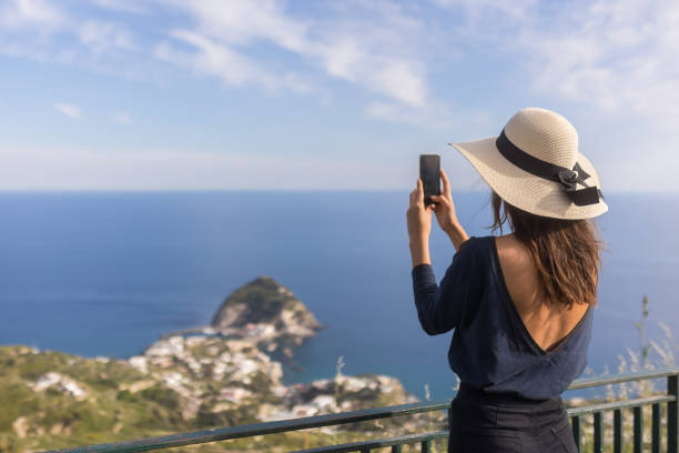 istock Young woman relaxes at coastal viewpoint 1396896332