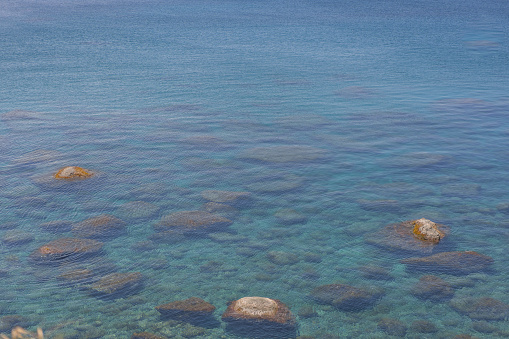 Rocks emerge to the water surface