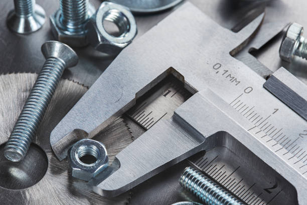 istock set of different nuts, bolts, screws, washers and drill bits,thread tap and mill cutters on steel plate background. Locksmithing deal. 1396899079