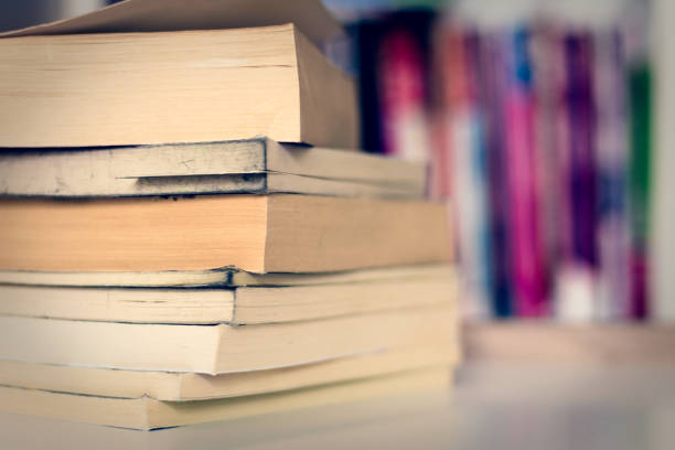 istock stacked books on table and blur background 1396899661