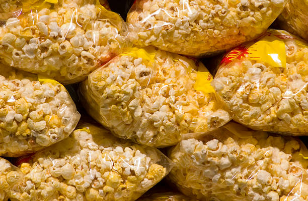 Bags of popcorn await customers at an amusement park stand in New England.