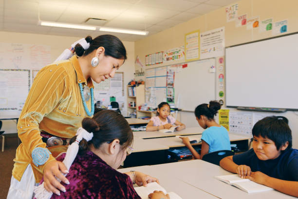 Elementary School Classroom Teacher and Students Indigenous Navajo students in an elementary school classroom. navajo stock pictures, royalty-free photos & images