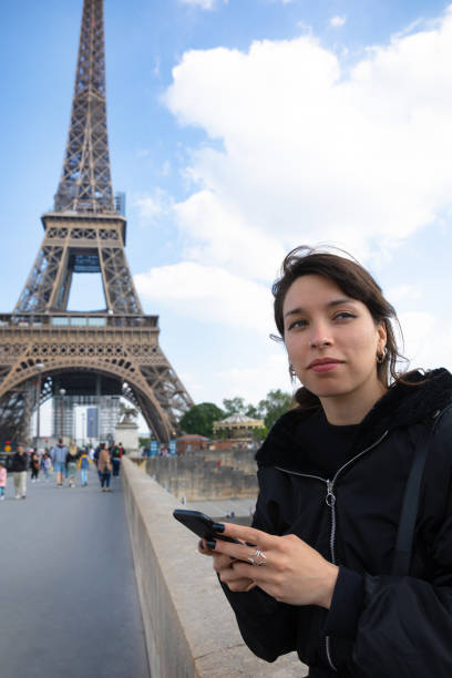 istock Young woman using smartphone in Paris 1396900630