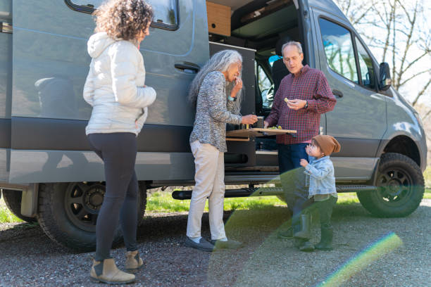 istock Family eating lunch outside camper van 1396900757