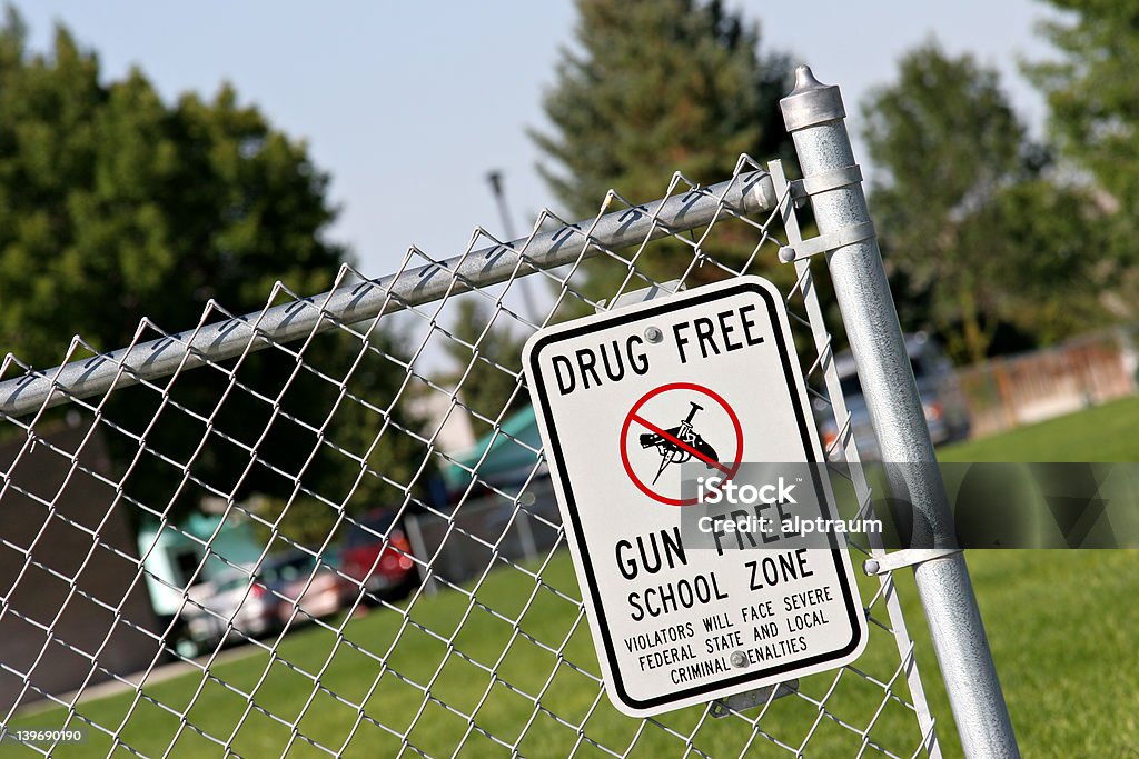 drug and gun free school zone drug and gun free school zone sign at a school yard. sign of the times. School Building Stock Photo