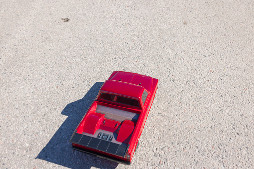 Close up top view of radio controlled vintage car model isolated on sidewalk. Sweden.