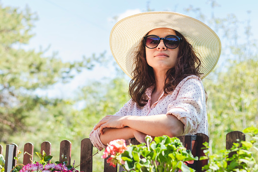 Adult woman 34 years old in sun hat in countryside.
