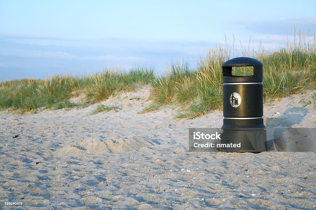 Bin on beach Black litter bin on a beach in the early evening denmark Beach Stock Photo