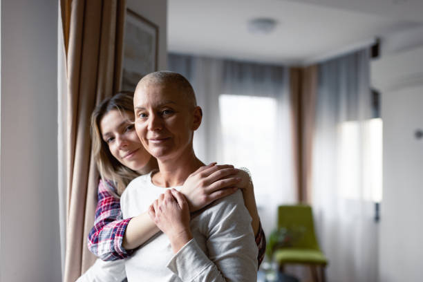 Woman with cancer and her daughter stock photo