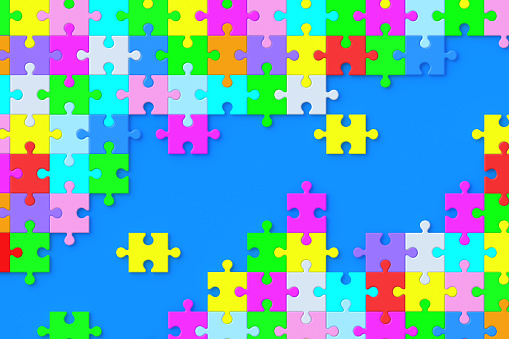 Lot of unfinished colorful puzzle jiggle pieces on violet background. Flat lay. 3d render