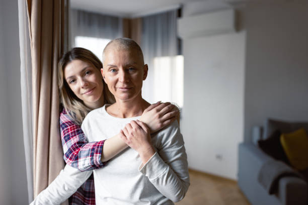 Woman with cancer and her daughter stock photo