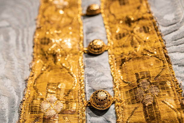 istock perspective of fabric and gold buttons on the fabric 1396910069