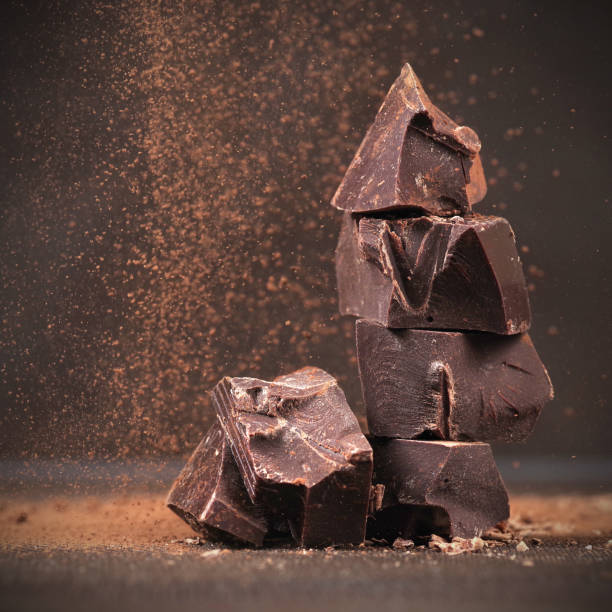 istock Broken dark chocolate and cocoa powder on a table 1396912247