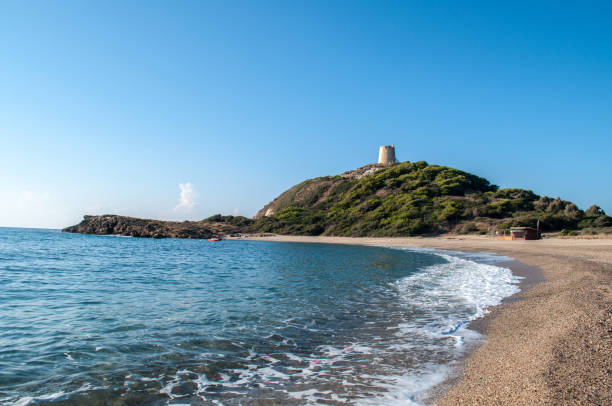 istock Sandy beach in the mountains and old tower in the background (Sardinia) 1396913153
