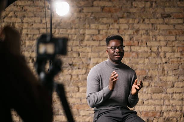 Young man giving an interview in a studio stock photo