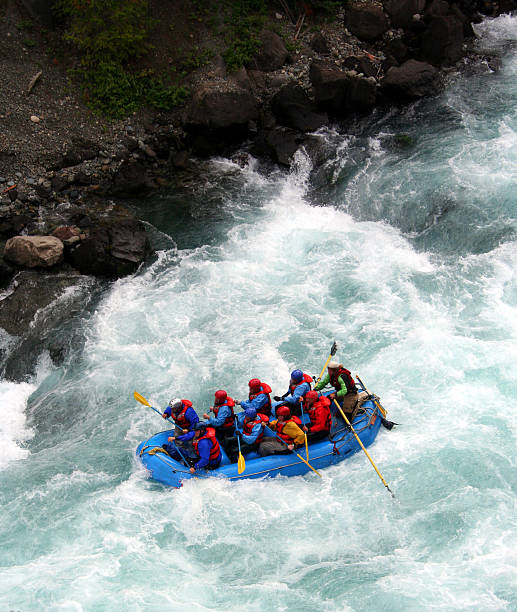 River Rafting a raft blasting through a wave rafting stock pictures, royalty-free photos & images