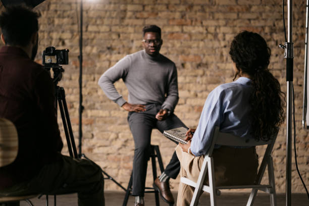 istock Female journalist interviewing a handsome young man 1396913444
