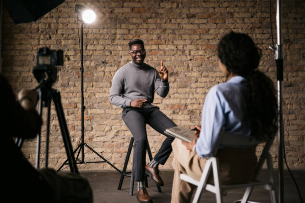 istock Female journalist interviewing a handsome young man 1396913535